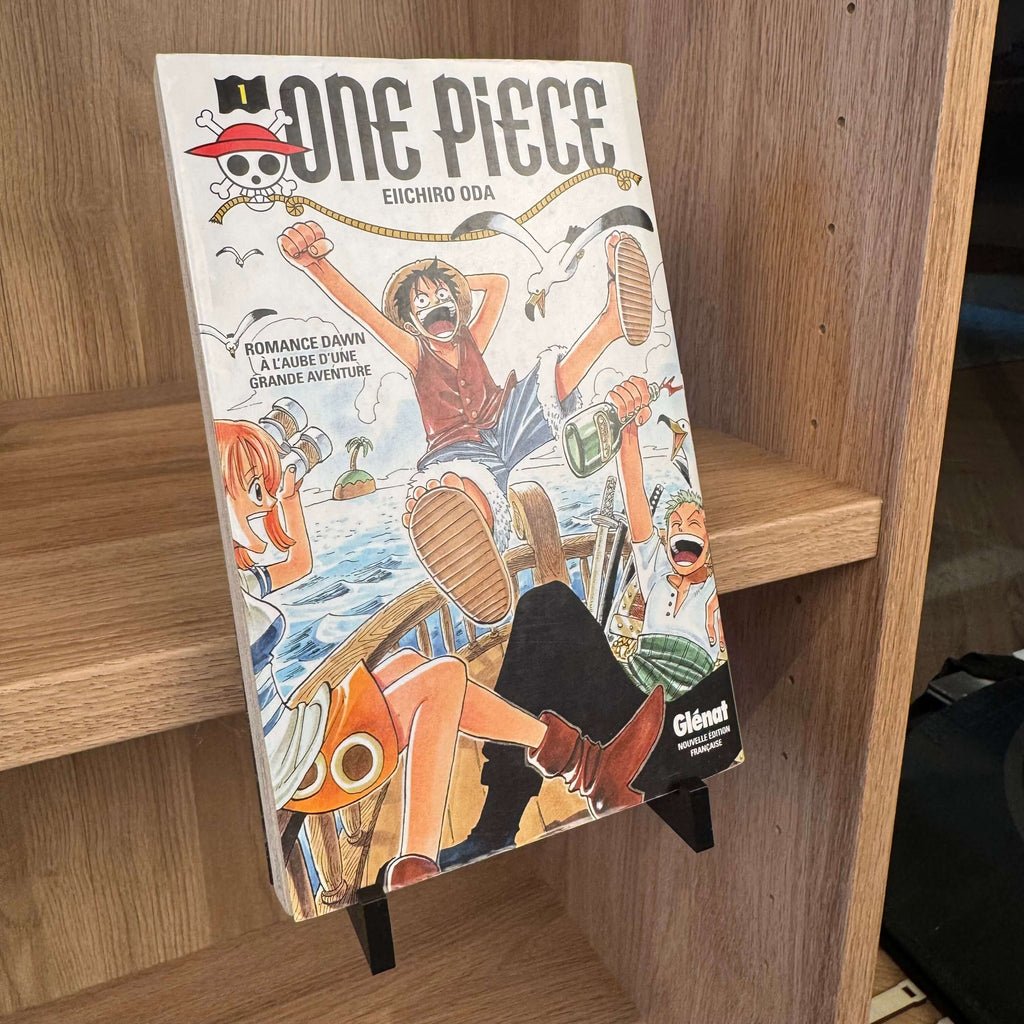 Présentoir à clipser noir maintenant un manga en position verticale